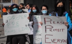 FILE - Nurses at Montefiore Medical Center Moses Division demand N95s and other critical personal protective equipment to handle the COVID-19 outbreak, in New York, April 2, 2020.