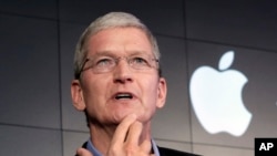 FILE – Apple CEO Tim Cook contends that complying with a government demand to help unlock an iPhone linked to a terrorist attack would endanger civil liberties. He’s shown at a 2015 news conference in New York. 
