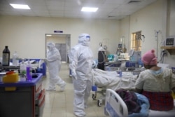 Medical staff dressed in protective suits treat coronavirus disease patients at the COVID-19 ICU of Machakos Level 5 Hospital, in Machakos, Kenya, Oct. 28, 2020.