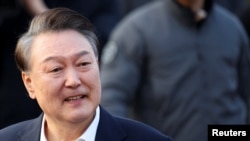South Korea's impeached President Yoon Suk Yeol reacts outside the Seoul detention center after his release, in Uiwang, South Korea, March 8, 2025.