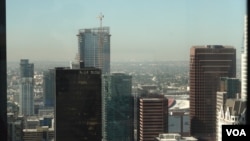 A photo of downtown Los Angeles skyline with the towering Oceanwide Plaza seen in the back with the crane. The Beijing based developer Oceanwide Holdings suspended the L.A. project in January and only a trickle of work has been spotted since then.