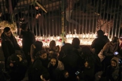 Iranians light candles for the victims of a Ukraine International Airlines crash during a gathering in front of Amirkabir University in Tehran, Jan. 11, 2020.