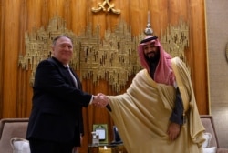 U.S. Secretary of State Mike Pompeo, left, shakes hands with Saudi Arabia's Crown Prince Mohammed bin Salman at Irqah Palace, in the capital Riyadh Saudi Arabia, Feb. 20, 2020.