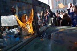 Protesters stand near a Minnesota National Guard vehicle Friday, May 29, 2020, in Minneapolis. Protests continued following the death of George Floyd, who died after being restrained by Minneapolis police officers on Memorial Day.