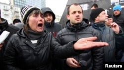 Pro-Russian supporters take part in a rally outside the regional administration in Donetsk. The US and the European Union imposed sanctions including asset freezes and travel bans on officials from Russia and Ukraine after Crimea applied to join Russia on referendum, March 17, 2014.
