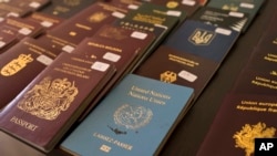 In this Wednesday, Feb. 28, 2018 photo Greek authorities present confiscated passports and identification cards at the Athens Police Headquarters.