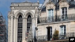 Wooden planks are pictured at Notre Dame cathedral, April 19, 2019 in Paris. Rebuilding Notre Dame, the 800-year-old Paris cathedral devastated by fire this week, will cost billions of dollars as architects, historians and artisans work to preserve the medieval landmark. 