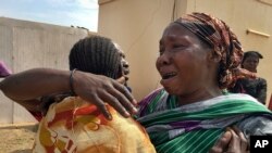 FILE - Relatives grieve as they wait to collect and bury the bodies of six aid workers who were ambushed and killed, outside the morgue in Juba, South Sudan, March 27, 2017. 