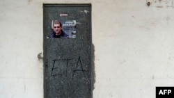 FILE - A poster is pasted on a door calling for the release of one of the most influential leaders of former Basque separatist group ETA, Josu Ternera, in the Spanish Basque village of Miraballes, May 16, 2019, after he was arrested in France. 