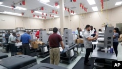 Employees at the Broward County Supervisor of Elections office count ballots during a recount in Lauderhill, Florida, Nov. 14, 2018.