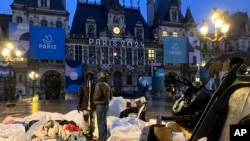 Grupos de migrantes frente al Ayuntamiento de París, el 3 de abril de 2024. 