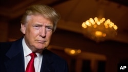 FILE - Then-Republican presidential candidate Donald Trump poses for a portrait after an interview in Sterling, Virginia, Dec. 2, 2015. 