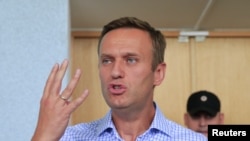 FILE - Russian opposition leader Alexei Navalny, who is charged with participation in an unauthorized protest rally, attends a court hearing in Moscow, July 1, 2019. 