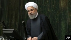 Iranian President Hassan Rouhani addresses lawmakers in an open session of parliament, in Tehran, Jan. 17, 2016.