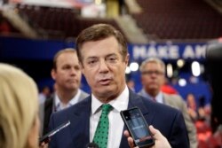 FILE - Trump Campaign Chairman Paul Manafort talks to reporters on the floor of the Republican National Convention at Quicken Loans Arena in Cleveland, July 17, 2016.