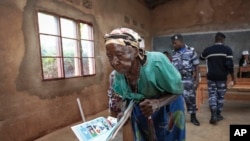 A woman walks to the polling booth to cast her vote in the presidential election, in Giheta, Gitega province, Burundi, May 20, 2020.