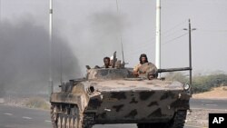 Yemeni Army forces move into the southern city of Zinjibar, Yemen after freeing it from the hands of al-Qaida-linked militants, September 10, 2011.