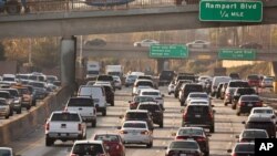 FILE - Traffic moves along the Hollywood Freeway in Los Angeles, California, Dec. 12, 2018.