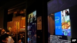 A ticket screen showing a scene of the movie "Far From Home", right, a short about the political division in Hong Kong following the anti-government protests in 2019, at a cinema in Hong Kong, June 11, 2021.