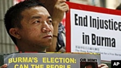 Members of the Hong Kong Coalition for a Free Burma, hold posters of Myanmar's detained opposition leader Aung San Suu Kyi during a demonstration in Hong Kong