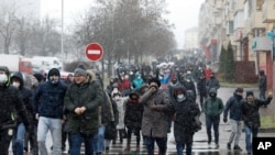 Demonstrators, some of them wearing face masks to help curb the spread of the coronavirus, attend an opposition rally to protest the official presidential election results in Minsk, Belarus, Nov. 29, 2020. 