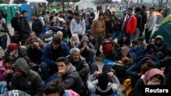 Migrants queue to receive travel papers near the Greek-Macedonian border, near the village of Idomeni, Greece, March 2, 2016. The European Union has proposed an emergency fund of $760 million to help Greece and other member states that are struggling with the migrant crisis.