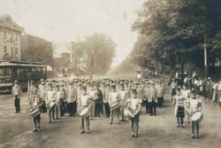 In this July 4, 1910 photo made available by the Library of Congress, United Confederate Veterans from the Civil War march with drummers down a street in Petersburg, Va.