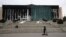 Municipal workers cover the burnt city hall building for repairs in Almaty, Kazakhstan, Jan. 13, 2022, following anti-government protests earlier this month that have since been quelled.