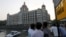 FILE - Tourists are seen in front of the Taj Mahal hotel, which was one of the targets of the Nov. 26, 2008 attacks, in Mumbai April 10, 2015. 