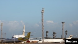FILE - Planes are seen at Mitiga Airport in Tripoli, Libya, Dec. 12, 2019.