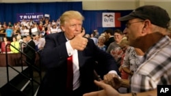 Republican presidential candidate Donald Trump greets supporters during a rally in Dubuque, Iowa, Aug. 25, 2015.