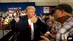 Republican presidential candidate Donald Trump greets supporters during a rally, Aug. 25, 2015, in Dubuque, Iowa.