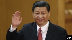 New Communist Party General Secretary Xi Jinping waves in Beijing's Great Hall of the People Nov. 15, 2012.