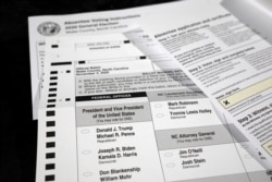 FILE - An absentee ballot and required paperwork await preparations at the Wake County Board of Elections on the first day that the state started mailing them out, in Raleigh, N.C., Sept. 4, 2020.