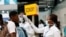 FILE - A health worker checks the temperature of a traveler as part of the coronavirus screening procedure at the Kotoka International Airport in Accra, Ghana, Jan. 30, 2020.