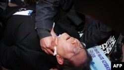 South Korean opposition party leader Lee Jae-myung is attended to after being attacked in Busan on Jan. 2, 2024.