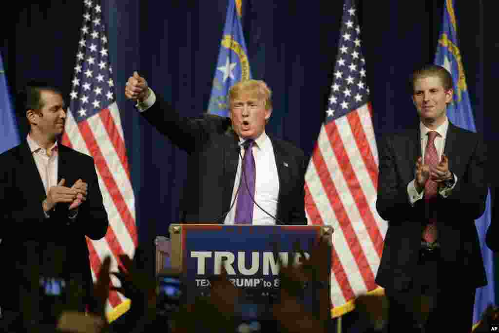 Republican presidential candidate Donald Trump, is flanked by his two sons, Donald Trump Jr., left, and Eric, while speaking at a caucus night rally Tuesday, Feb. 23, 2016.
