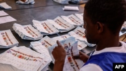 An Electoral Commission of Namibia (ECN) official counts ballots at the Namibia University of Science and Technology polling station in Windhoek on Nov. 28, 2024, following the country's general election. 