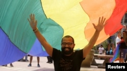 FILE - LGBT community members and activists demostrate in front of the Supreme Court of Justice, to demand for same-sex marriage, in San Jose, Costa Rica, Aug. 4,2018. 