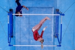 Jade Carey of United States performs on the uneven bars during women's artistic gymnastic qualifications at the 2020 Summer Olympics, July 25, 2021, in Tokyo.