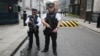Armed police officers pose for the media in Downing Street, central London, Aug. 29, 2014. 
