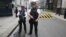 Armed police officers pose for the media in Downing Street, central London, Aug. 29, 2014. 