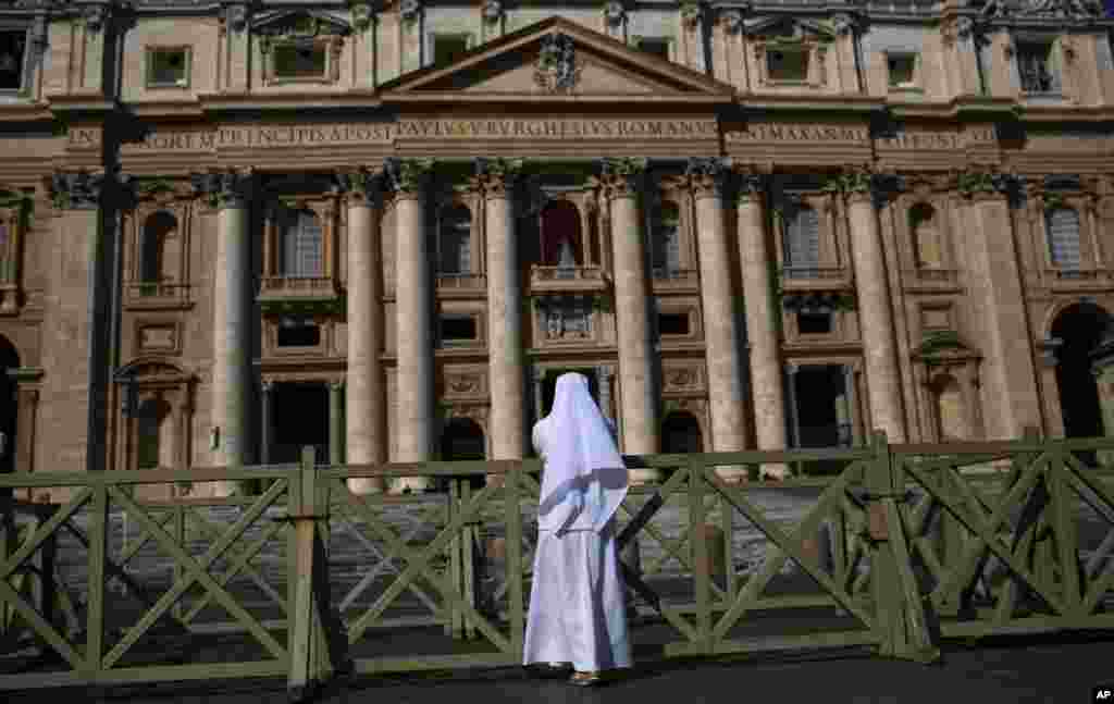 Sister Veronica of the Theresian community prays in St. Peter's Square, at the Vatican, March 12, 2013. 