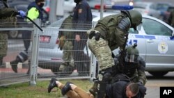Police detain a man during an opposition rally to protest the official presidential election results in Minsk, Belarus, Nov. 1, 2020.