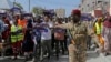 FILE - A Somali soldier controls the crowd as thousands of people rally in Mogadishu, Somalia, on Jan.3, 2024, protesting an agreement signed between Ethiopia and the breakaway region of Somaliland to give landlocked Ethiopia access to its shoreline. 