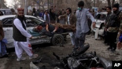 Pakistani volunteers remove a victim at the site of a suicide bombing in Quetta, Feb. 17, 2020.
