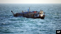 In this photo provided by the U.S. Navy, the Iran-flagged, Ya-Hussayn, takes on water in the Persian Gulf, January 10, 2012.