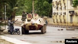 Malian military junta troops who carried out a coup in March guard a street after renewed fighting in the capital Bamako, May 1, 2012. 
