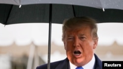 U.S. President Donald Trump speaks to reporters as he and first lady Melania Trump depart for travel to a NATO summit in London, from the White House in Washington, Dec. 2, 2019. 